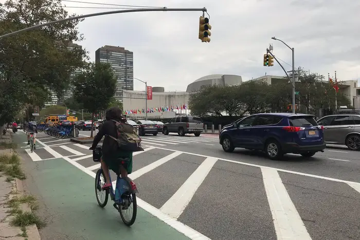 A bicyclist in a bike lane near the United Nations.